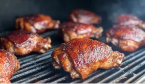 Smoked chicken thighs with crispy skin, perfectly cooked on a BBQ smoker.