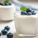 A variety of yogurt types displayed in containers, highlighting protein-rich options like Greek, Skyr, and plant-based yogurt.