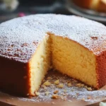 Butter cake slice next to a dense pound cake slice on a white plate.